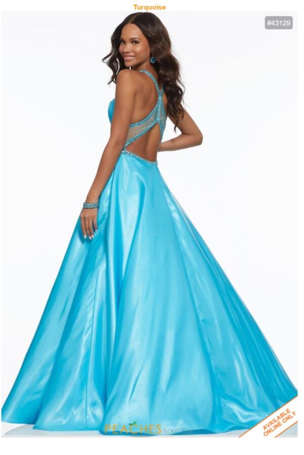 model wears turquoise ball gown