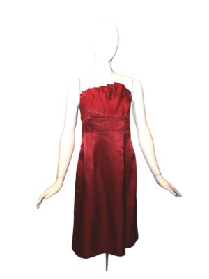 Satin red dress with pleats on mannequin