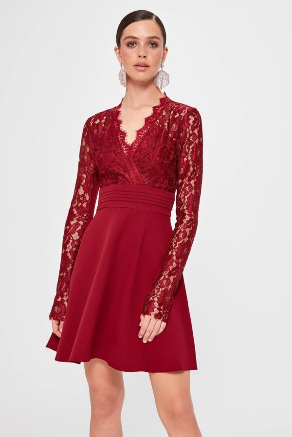 model wears burgundy dress with long sleeves