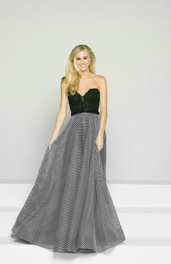 model wears ballgown with black and white striped skirt
